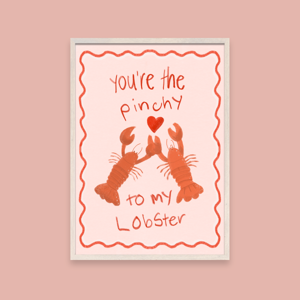 Illustration of two orange lobsters holding claws with a heart and text "You're the Pinchy to my Lobster" on a pink poster with a squiggly red outline. The framed poster sits on top of a deep pink background.